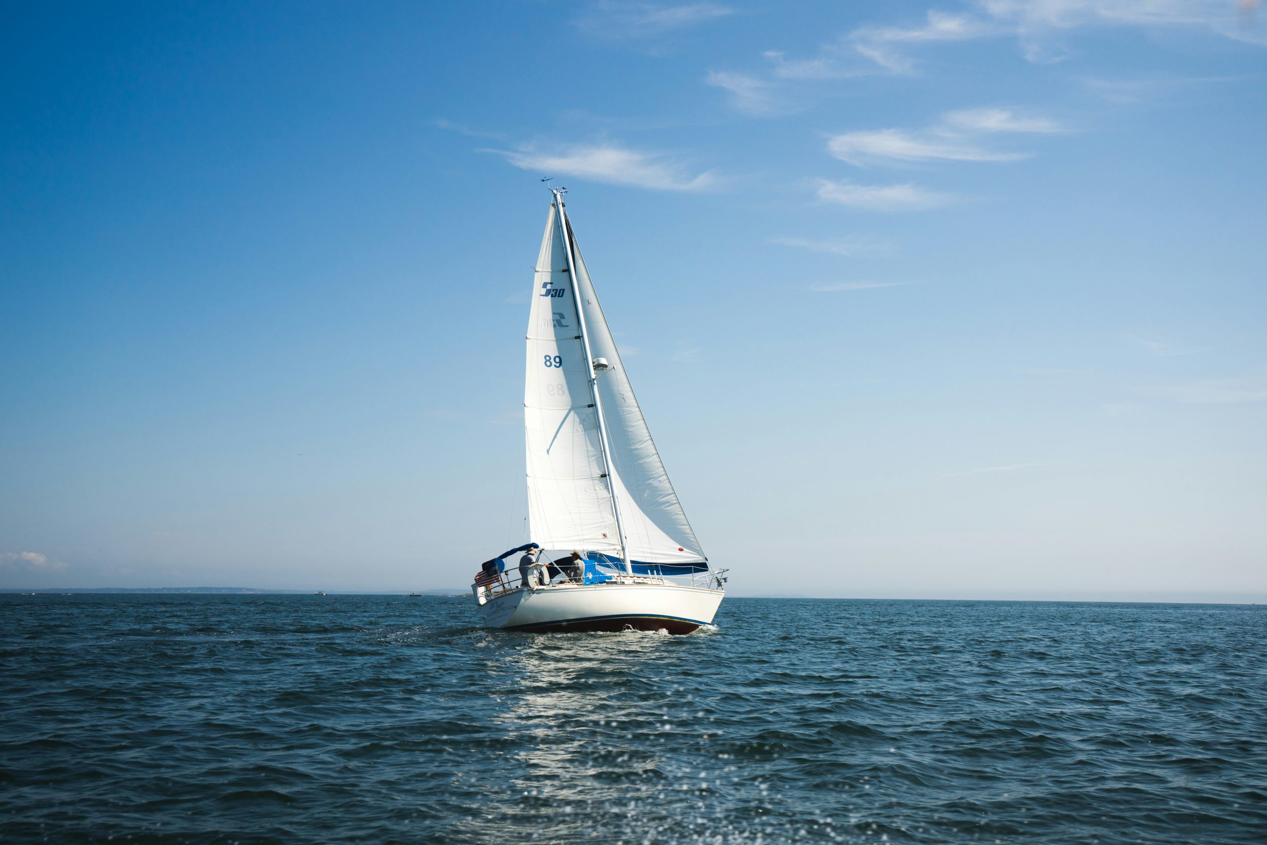 Sailboat on calm blue waters.